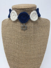 Load image into Gallery viewer, Close up picture of a Blue and ivory hand-knitted pet collar with star of David star around a tan brown bust