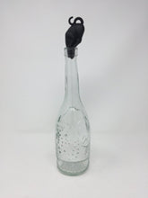 Load image into Gallery viewer, Picture of a black cat-themed bottle stopper with the cat's face inside the top of the bottle with a white background