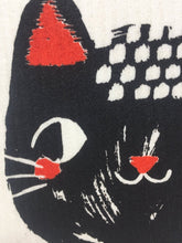 Load image into Gallery viewer, Close up picture of a black cat's face on a white sponge dish rack towel