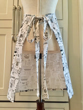 Load image into Gallery viewer, Back view of a black and white kitchen apron