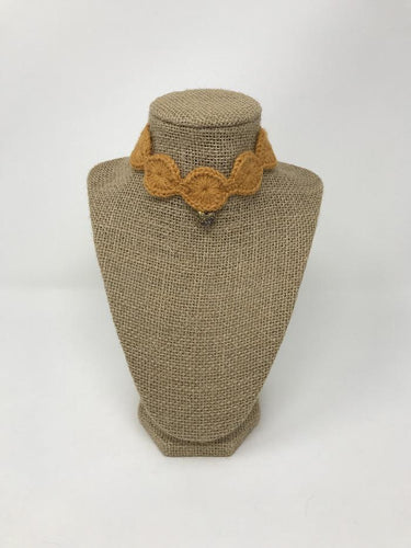 Picture of a ginger colored pet collar with a gold colored charm around a tan brown bust 